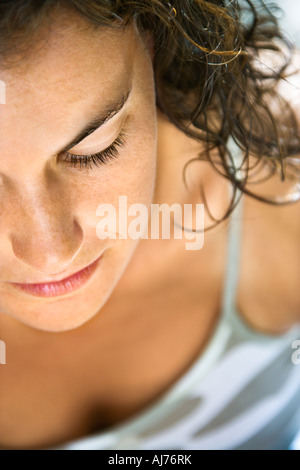Close up of pretty young adult Caucasian brunette womans face with eyes closed Stock Photo