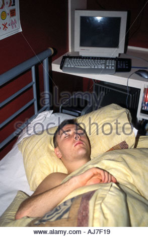 16 Year Old Boy Asleep In His Bed In Bedroom Uk Stock Photo