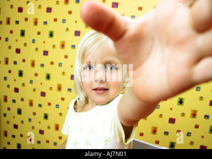 indoor flat room wall paper design designs girl child blonde smile smiling come up Stock Photo