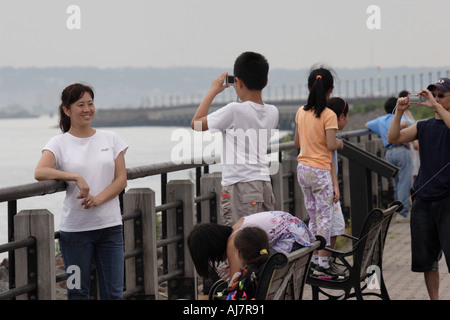 An asian family taking pictures at Asian Kite Festival in Liberty State Park New Jersey Stock Photo