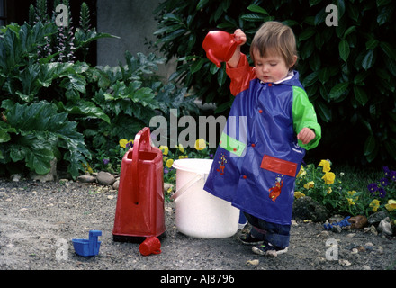 France Southwest . Three-year old girl into some serious gardening. Stock Photo