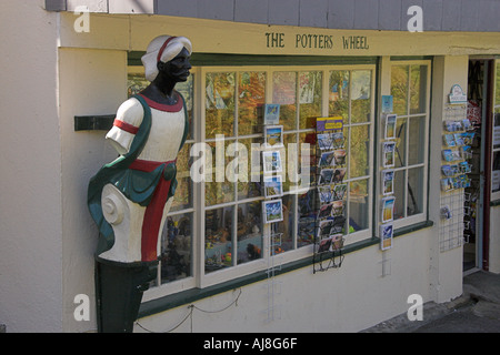 Ship Figurehead and Shop Window, Mullion Village, Cornwall, UK Stock Photo