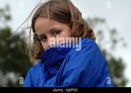 young girl outdoors on a winter day shivering with cold Stock Photo