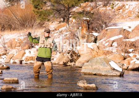 Man winter fly-fishing in Colorado. Stock Photo