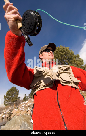 Man winter fly-fishing in Colorado. Stock Photo