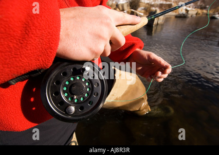 Man winter fly-fishing in Colorado. Stock Photo