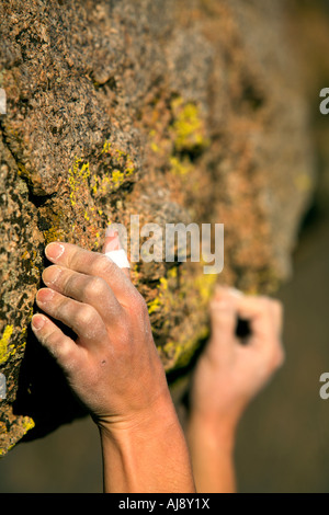 A climber's hands grip onto rock Stock Photo