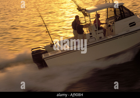 Fishing Boat Coming In At Sunset Stock Photo - Alamy