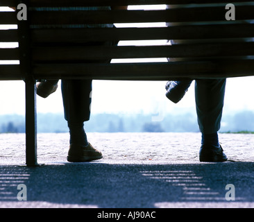 communication generic image of relaxing elderly men on a park bench in north london in the summer time Stock Photo