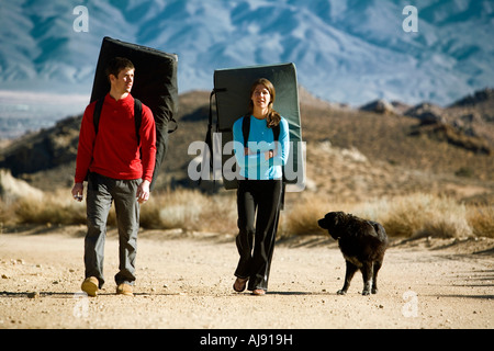 Two climbers, crash pads and dog Stock Photo
