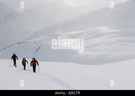 Young adults ski-tour in mountains Stock Photo