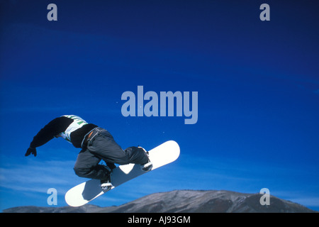 Snowboarder jumping in air. Stock Photo