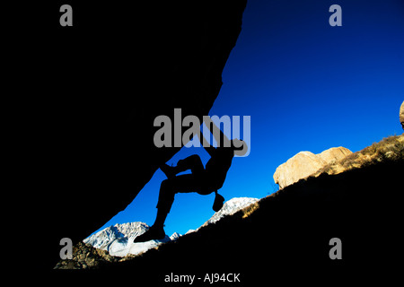 Man bouldering on an overhang. Stock Photo
