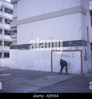 A man plays football on a housing estate in Gibraltar.2002. Stock Photo