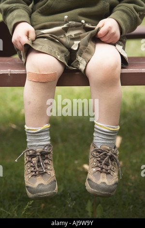 Boy with Bandaid on Knee Stock Photo