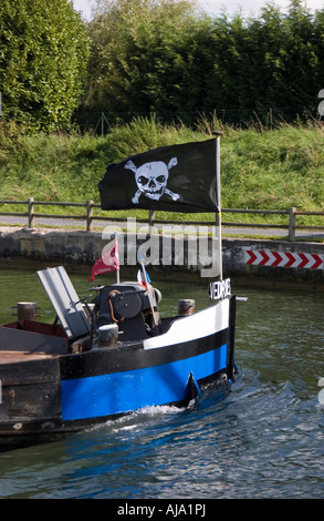 Bow and forecastle of commercial barge on the Canal du Nord in France The barge is flying the skull and cross bones Stock Photo
