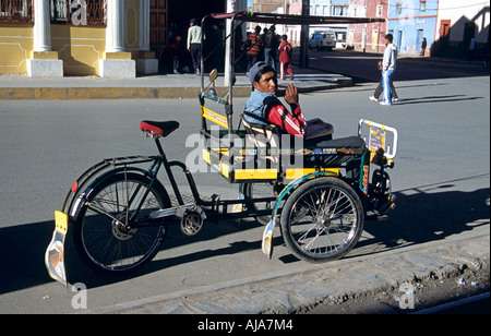 Man sitting on tricycle taxi, Puno, Peru Stock Photo