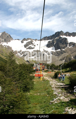 Two people sitting in a chair lift on the way to the Usuhaia glacia Stock Photo