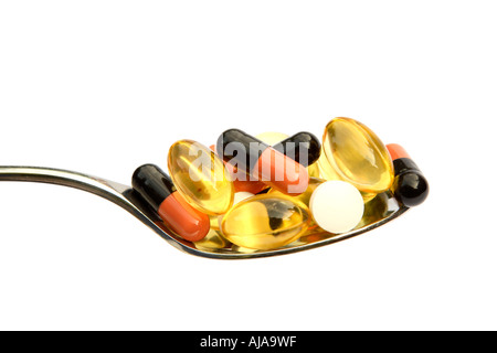 Spoonful of various different drugs isolated on white Stock Photo