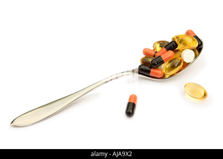 Spoonful of various different drugs isolated on white Stock Photo