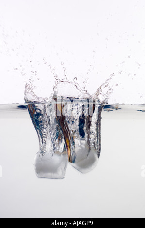 ice cubes falling into water Stock Photo