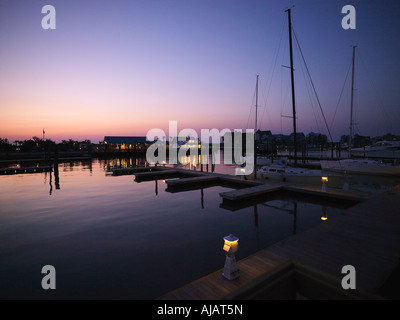 Ferry boat and sail boats at marina at dusk at Bald Head Island North Carolina Stock Photo