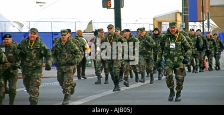 This troop of army soldiers in camouflage green are seen in downtown Salt Lake City, Utah, USA during the 2002 Olympics. Stock Photo