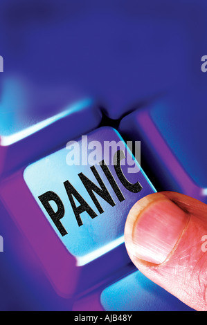 finger on panic key button on computer keyboard Stock Photo