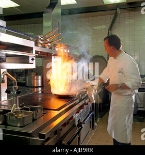 Chef cooking food in with flames in London 101 restaurant London W1 England HXXZsm Stock Photo