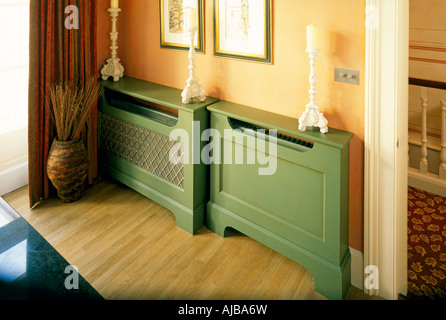 Wooden radiator panel covers in domestic interior MJXZsm Stock Photo