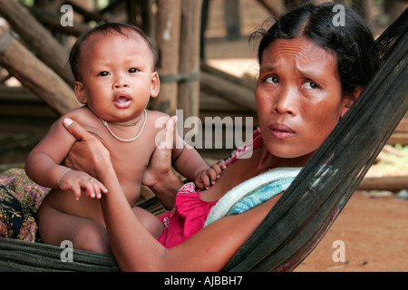 Mother and child in a hammock at the village of Kompong Phhluk, Tonle Sap, Nr Siem Reap, Cambodia. Stock Photo