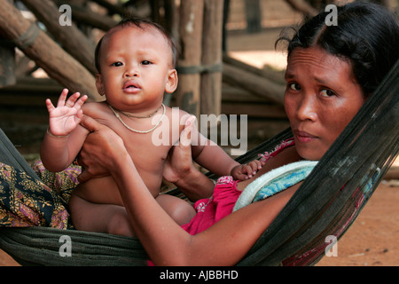 Mother and child in a hammock at the village of Kompong Phhluk, Tonle Sap, Nr Siem Reap, Cambodia. Stock Photo