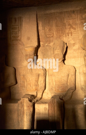 statues of Amun Ra god of the sun in Luxor Thebes and King Ramses II after sunrise at the Temple of Abu Simbel Egypt Africa Stock Photo