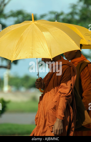 Cambodia Closeup Of Young Buddhist Monks Walking Holding Umbrellas Phnom Penh Stock Photo