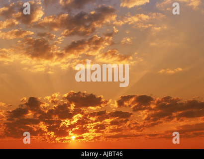 Sun rays bursting through cloudy skies Stock Photo
