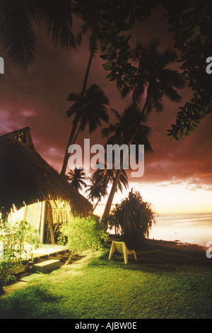 Hut illuminated at dusk on Moorea Island in French Polynesia Stock Photo