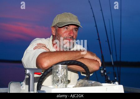 Fishing rod wheel man fishing from fisherman boat in Florida. Wearing  smartwatch wearable technology for outdoor sport Stock Photo - Alamy