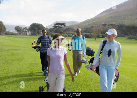 Golfers Walking Down Fairway Talking Stock Photo