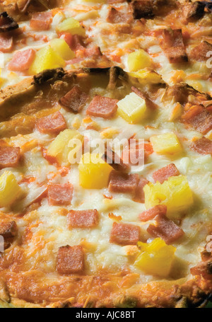 pizzas with cheese and pineapple cooked unitl golden brown often ordered from a take away or Italian restaurant Stock Photo