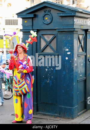 Performer standing next to a blue police box during the Fringe Festival in Edinburgh Stock Photo