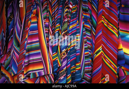 Selection of brightly coloured woven shawls zutes for sale at market Chichicastenango Guatemala Stock Photo