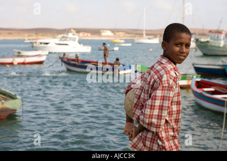 Young boy play football Palmeira seaport Sal island Cape Verde Stock Photo