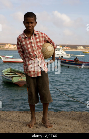 Young boy play football Palmeira seaport Sal island Cape Verde Stock Photo