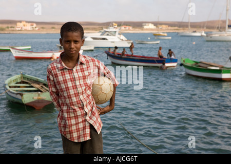 Young boy play football Palmeira seaport Sal island Cape Verde Stock Photo