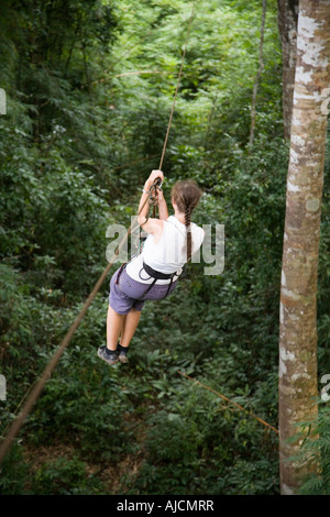 woman on a zip line at The Gibbon Experience near Huay Xai on the Mekong river near the Laos Thai border Stock Photo