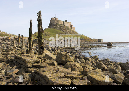 Lindisfarne Castle on the Northumberland coast England as seen from across the bay at low tide Stock Photo