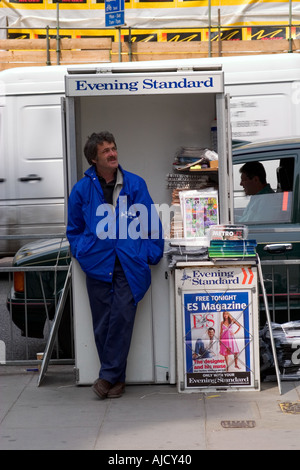 Evening Standard newspaper vendor at his pitch in Knightsbridge London Stock Photo