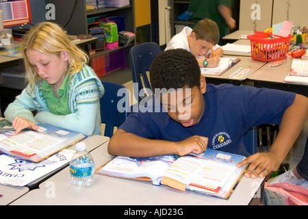 Fouth grade students read textbooks in a classroom at a public school in Tampa Florida Stock Photo