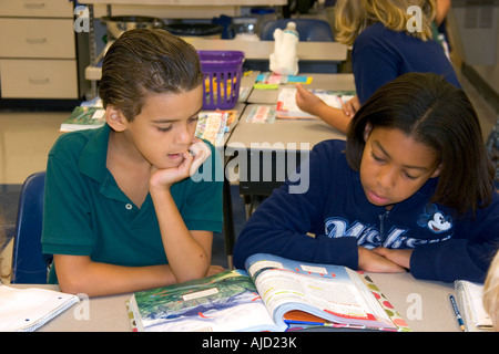 Fourth grade students read textbooks in a classroom at a public school in Tampa Florida Stock Photo