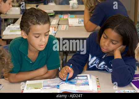 Fouth grade students read textbooks in a classroom at a public school in Tampa Florida Stock Photo